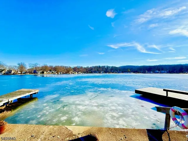 a view of a lake with houses in the back