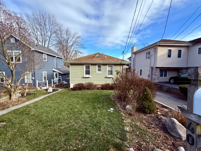 a view of empty room with wooden floor and window