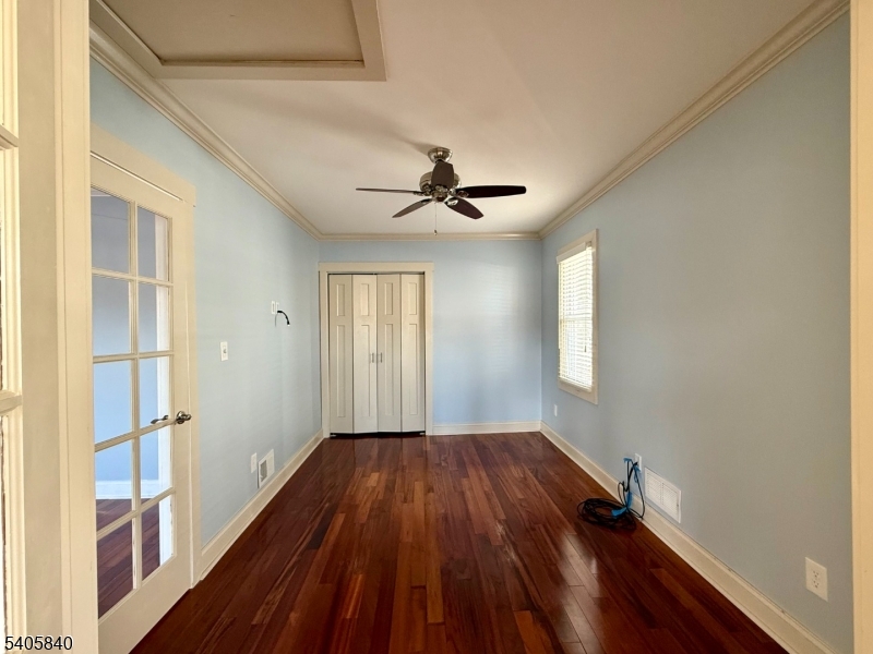 40 West Shore Road Denville, NJ 07834 - Photo 10 of 31 a view of empty room with wooden floor and fan