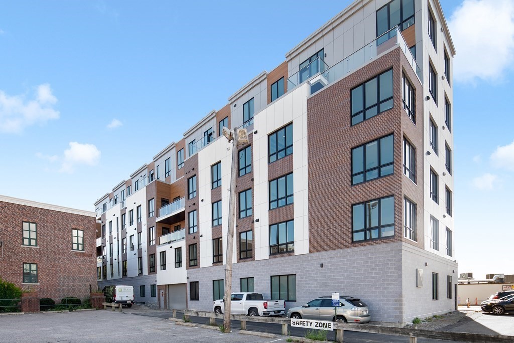 20 West Fifth Street, Unit PH6F Boston, MA 02127 - Photo 1 of 7 a front view of a building with lot of cars and trees