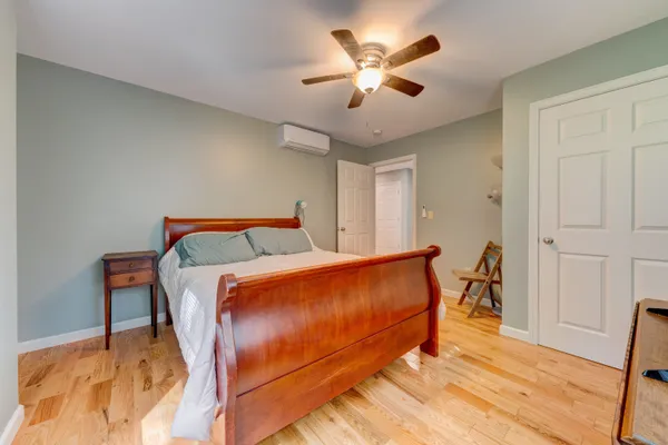 a spacious bedroom with a bed and a flat screen television