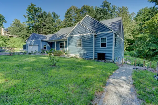 a front view of house with yard and green space