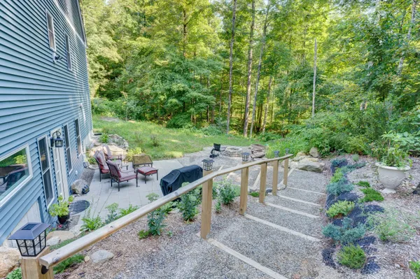 a view of a house with backyard and sitting area