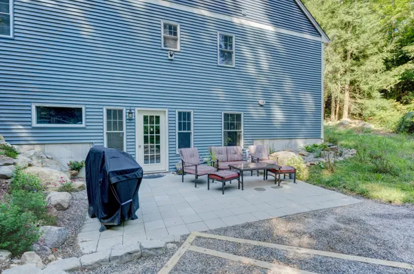 a view of a patio with couple of chairs and a table