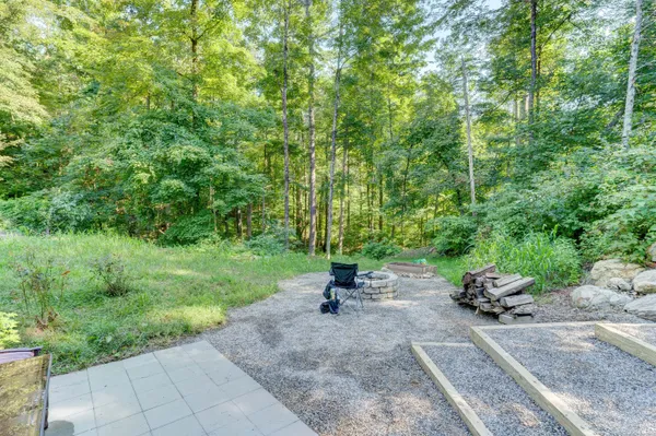 a view of a house with a yard and sitting area