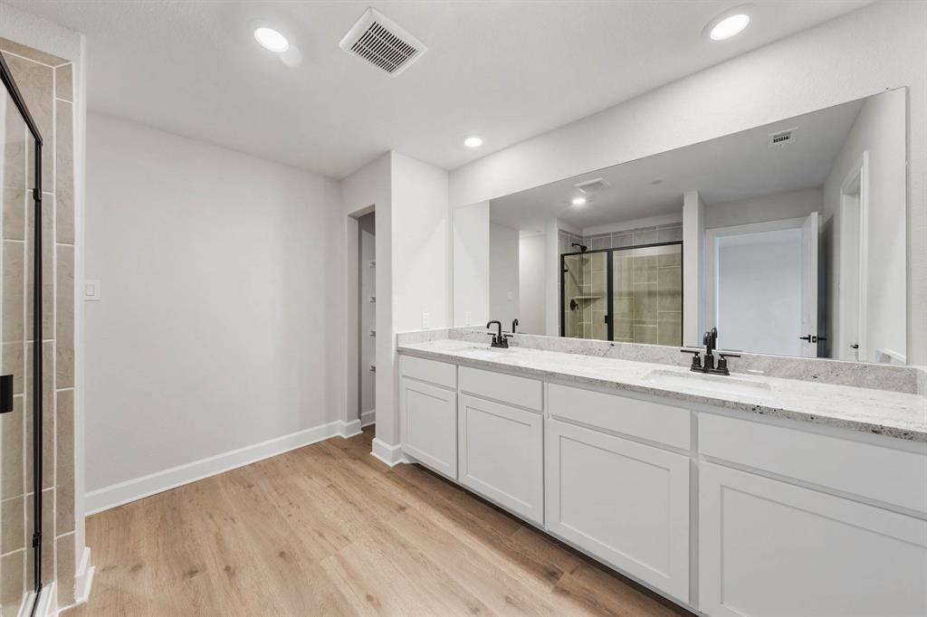 736 Carson Lane Pilot Point, TX 76258 - Photo 5 of 8 a spacious bathroom with a double vanity sink and mirror
