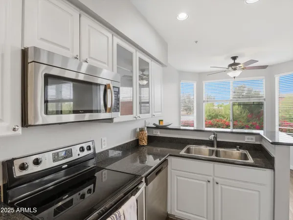 a kitchen with a sink stove and microwave
