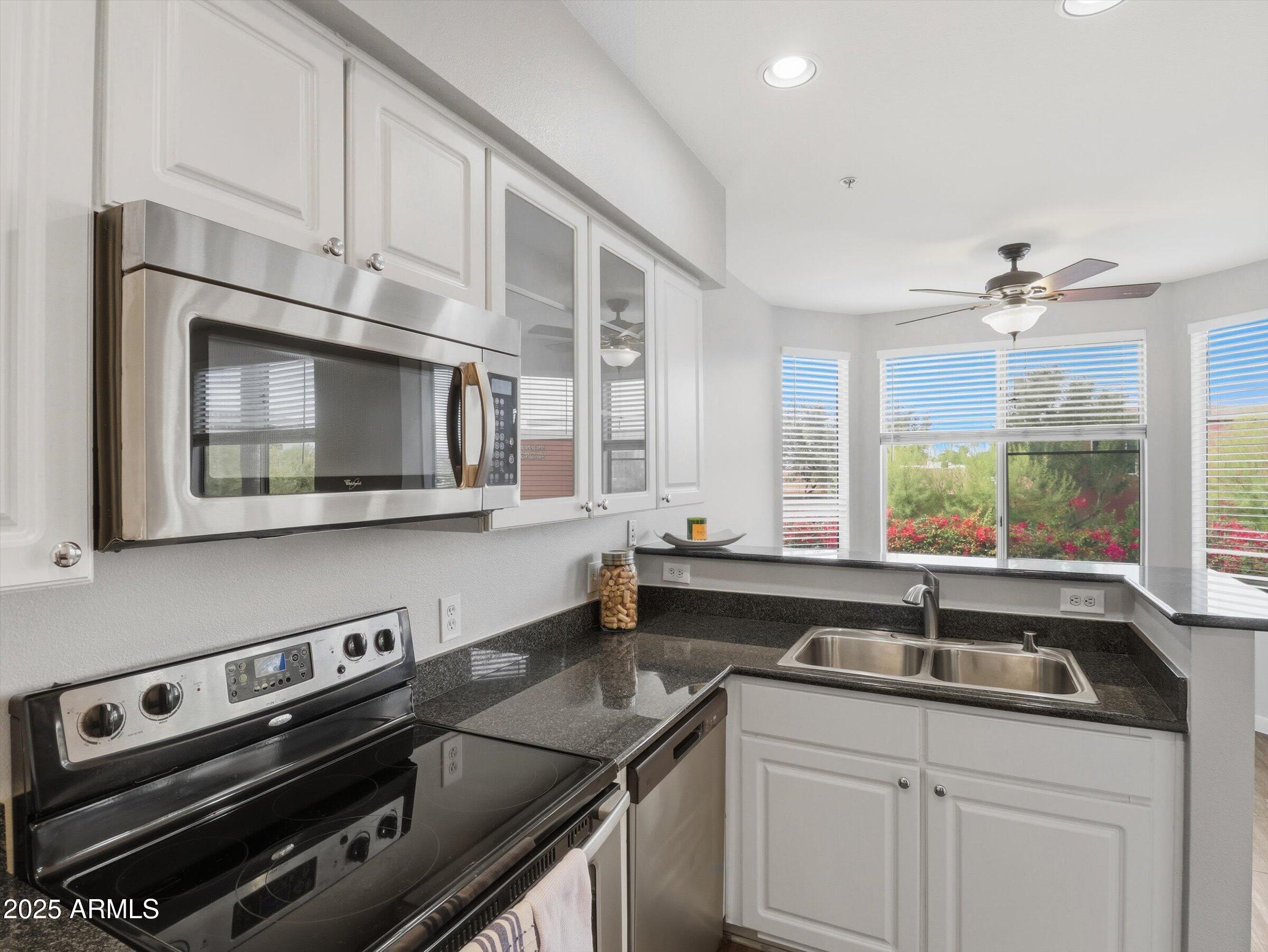 a kitchen with a sink stove and microwave