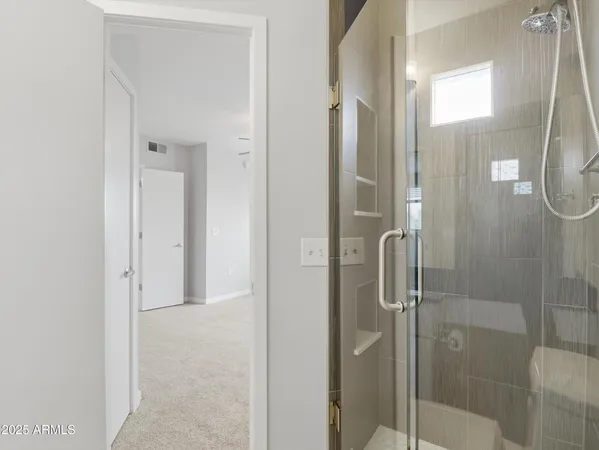 a bathroom with a glass shower door