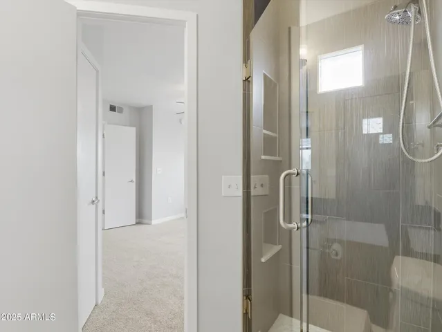 a bathroom with a glass shower door