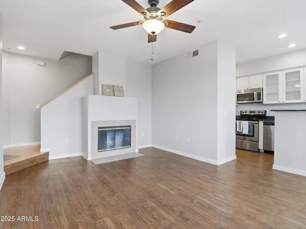 a view of a kitchen with a sink a kitchen counter top and a fireplace