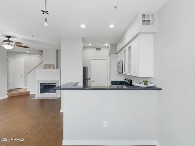 a view of a kitchen with furniture and a fireplace