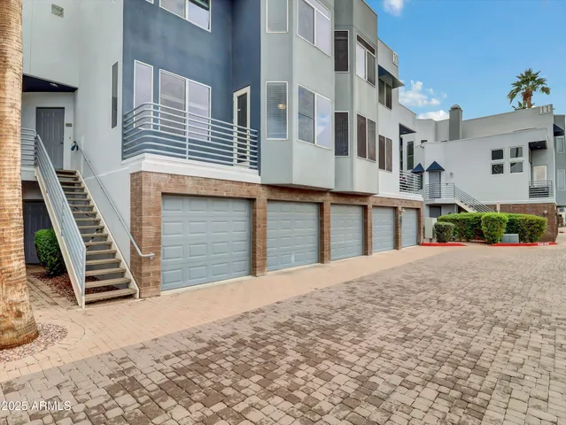 a front view of a building with a garden