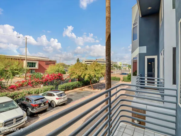a view of a patio with couches and table and chairs and potted plants