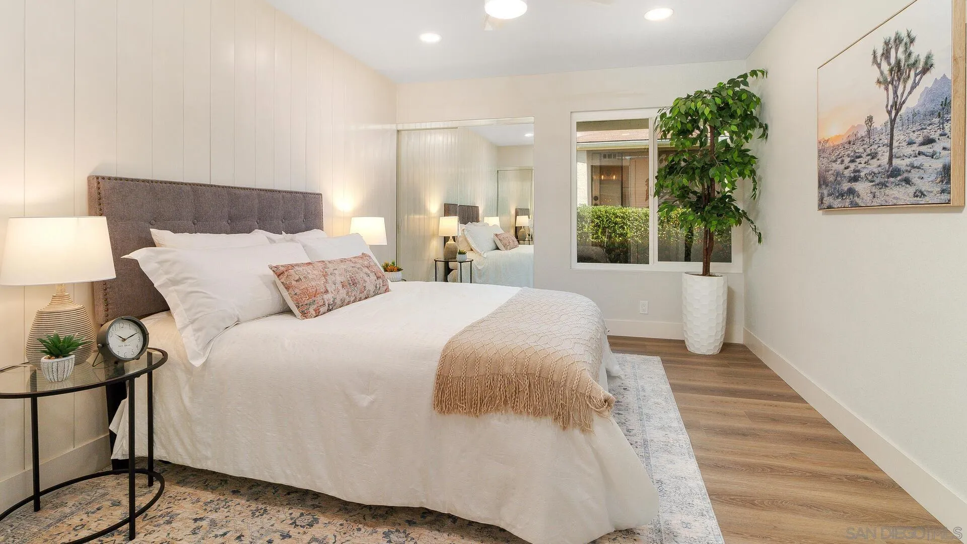 1371 Evergreen Drive Cardiff, CA 92007 - Photo 17 of 25 a bedroom with a large bed and a potted plant
