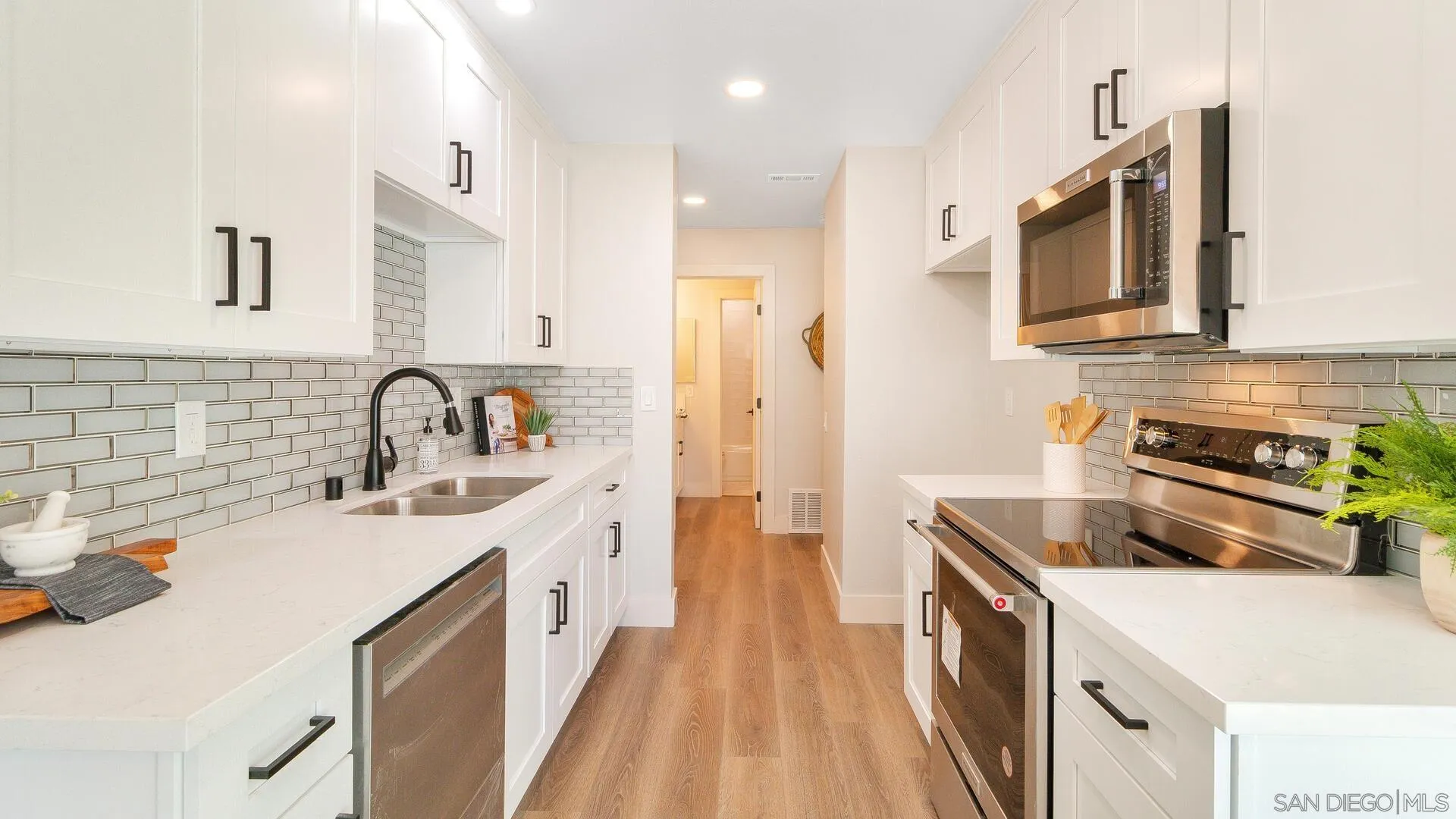 1371 Evergreen Drive Cardiff, CA 92007 - Photo 9 of 25 a kitchen with a sink stove and refrigerator