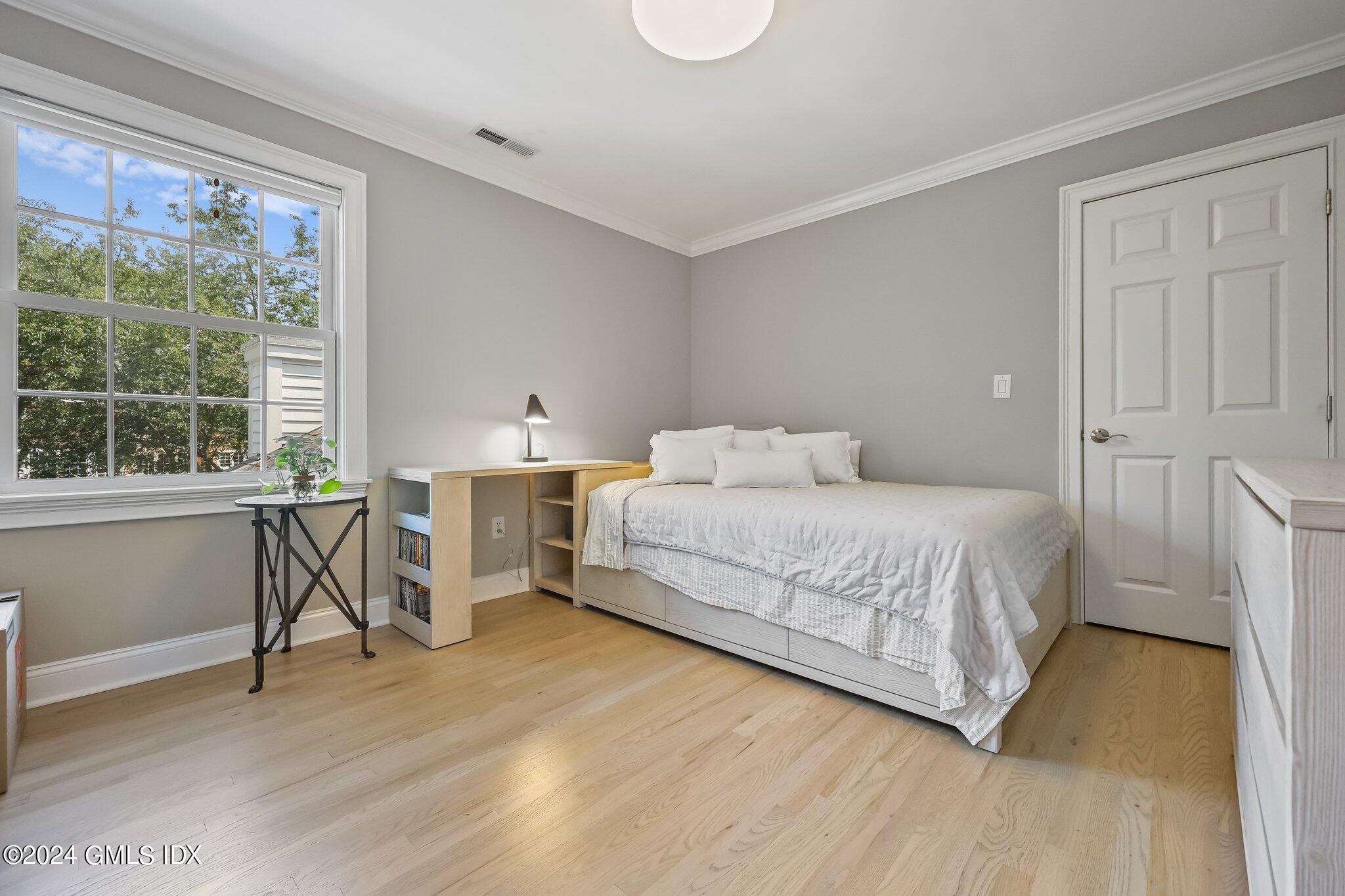 4 Grimes Road Old Greenwich, CT 06870 - Photo 15 of 22 a bedroom with a bed and a table in it