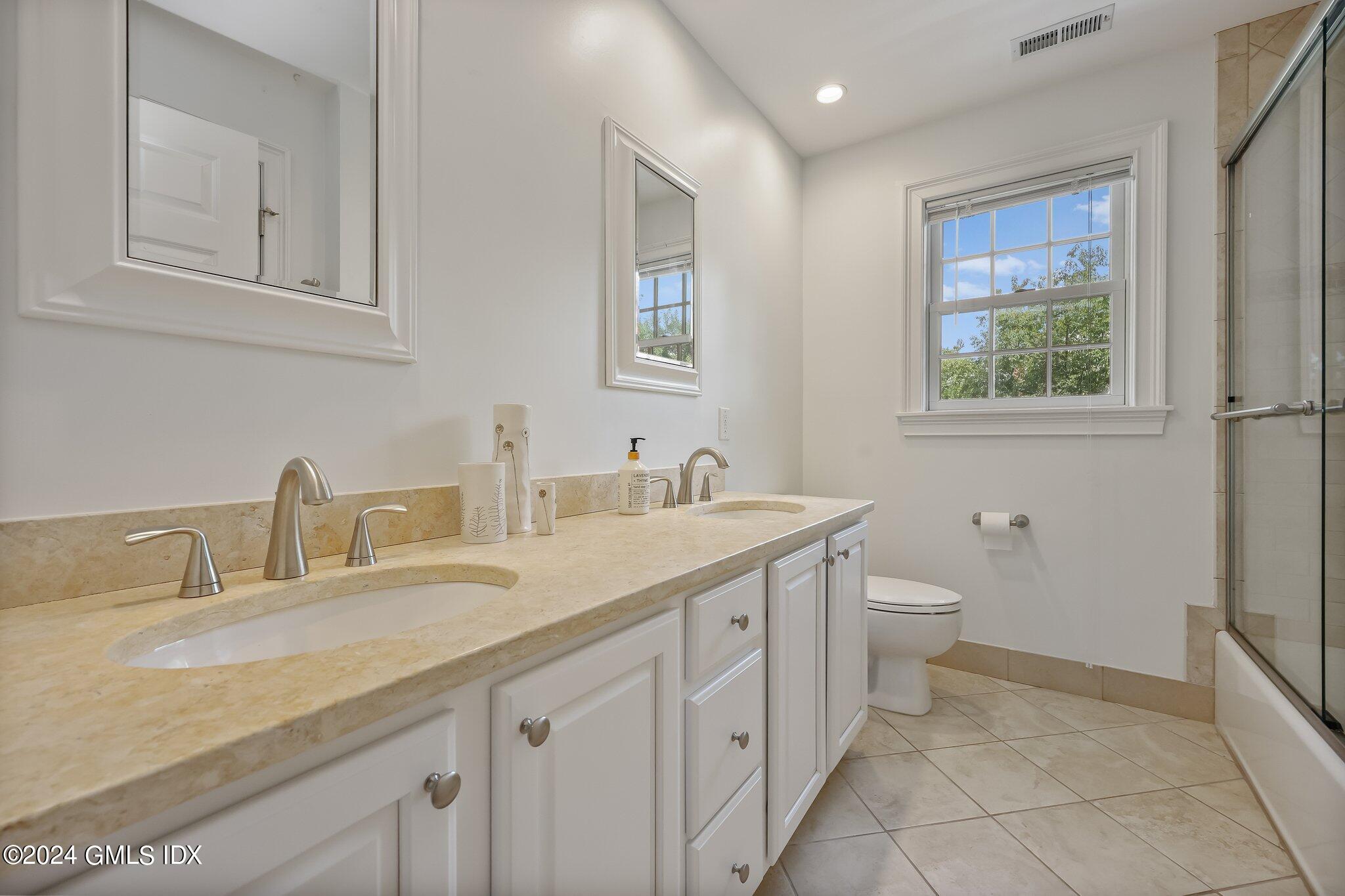 4 Grimes Road Old Greenwich, CT 06870 - Photo 16 of 22 a bathroom with a granite countertop sink mirror and toilet