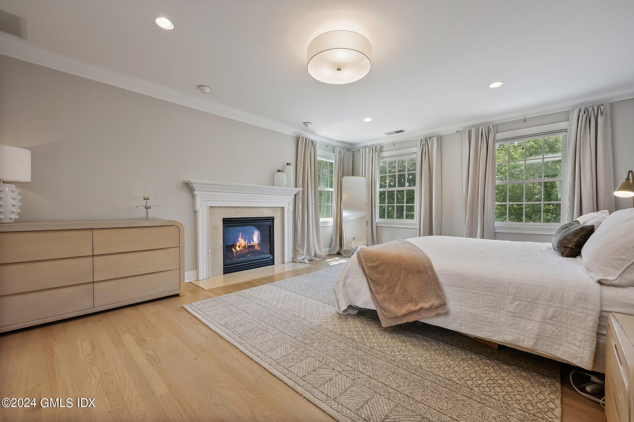 4 Grimes Road Old Greenwich, CT 06870 - Photo 10 of 22 a bedroom with a bed and a fireplace