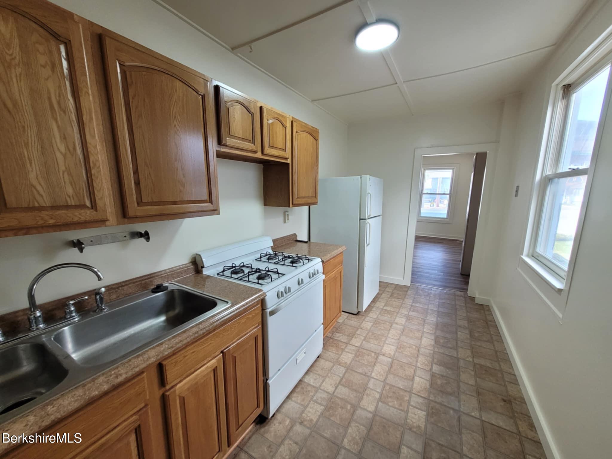 35 Pleasant Street Adams, MA 01220 - Photo 2 of 7 a kitchen with a sink stove and cabinets