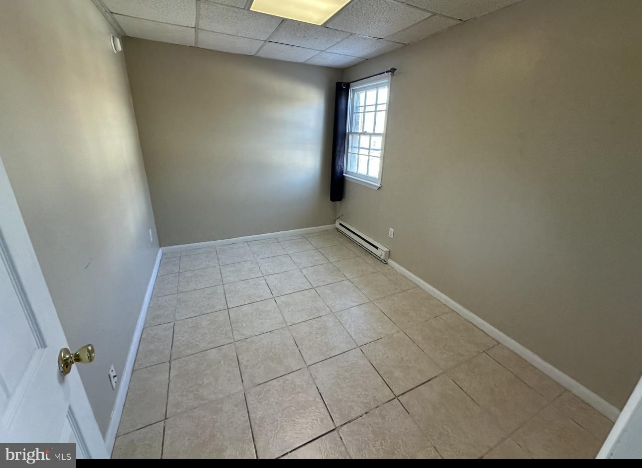 4430 Solly Avenue, Unit 2 Philadelphia, PA 19136 - Photo 12 of 13 an empty room with windows