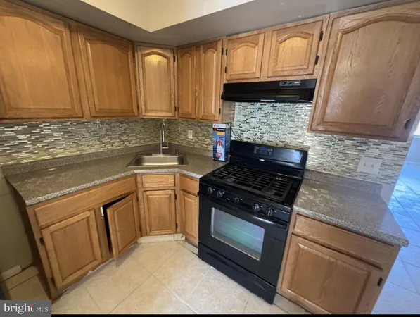 a kitchen with granite countertop cabinets and steel stainless steel appliances