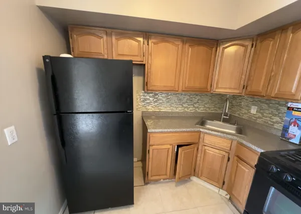 a kitchen with a refrigerator and cabinets