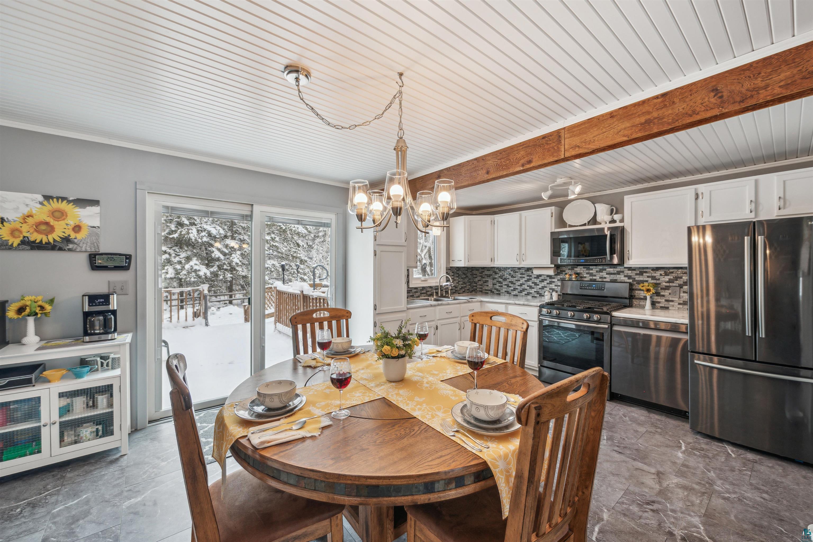 7212 County Road East South Range, WI 54874 - Photo 11 of 34 Dining can be taken outside as well onto the low-maintenance composite deck.