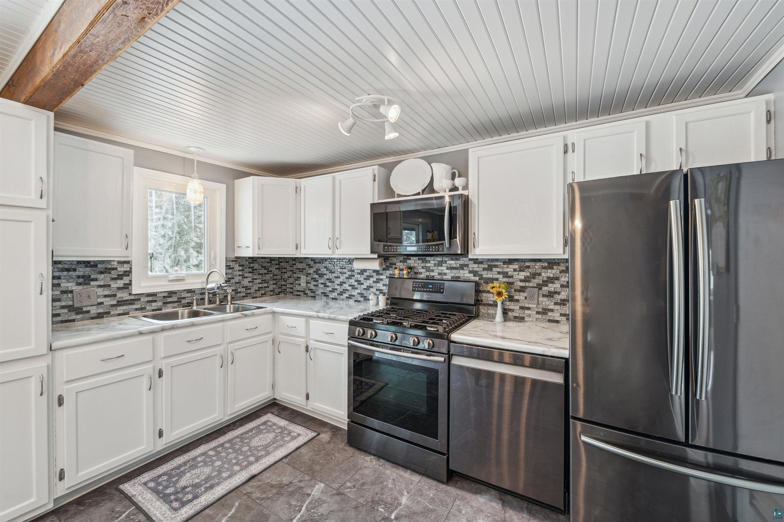 7212 County Road East South Range, WI 54874 - Photo 12 of 34 Kitchen with efficient layout and newer stainless steel appliances inc. gas stove.