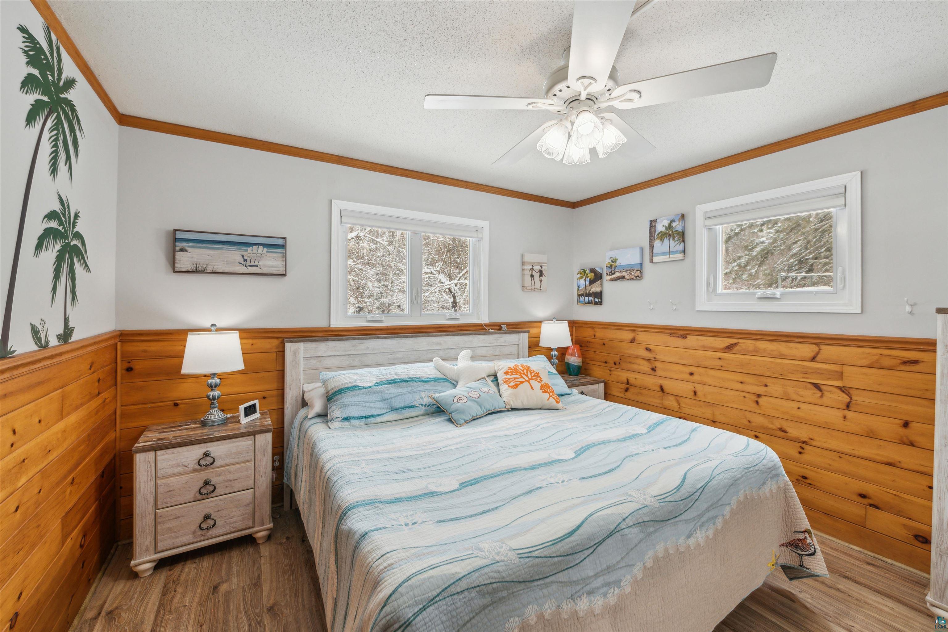 7212 County Road East South Range, WI 54874 - Photo 15 of 34 What a happy space! Bedroom has wainscoted walls and lots of natural light.