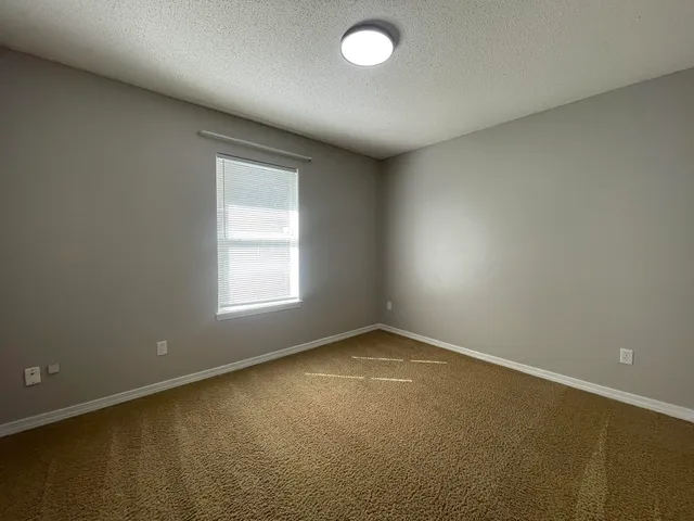 an empty room with a empty space and a window