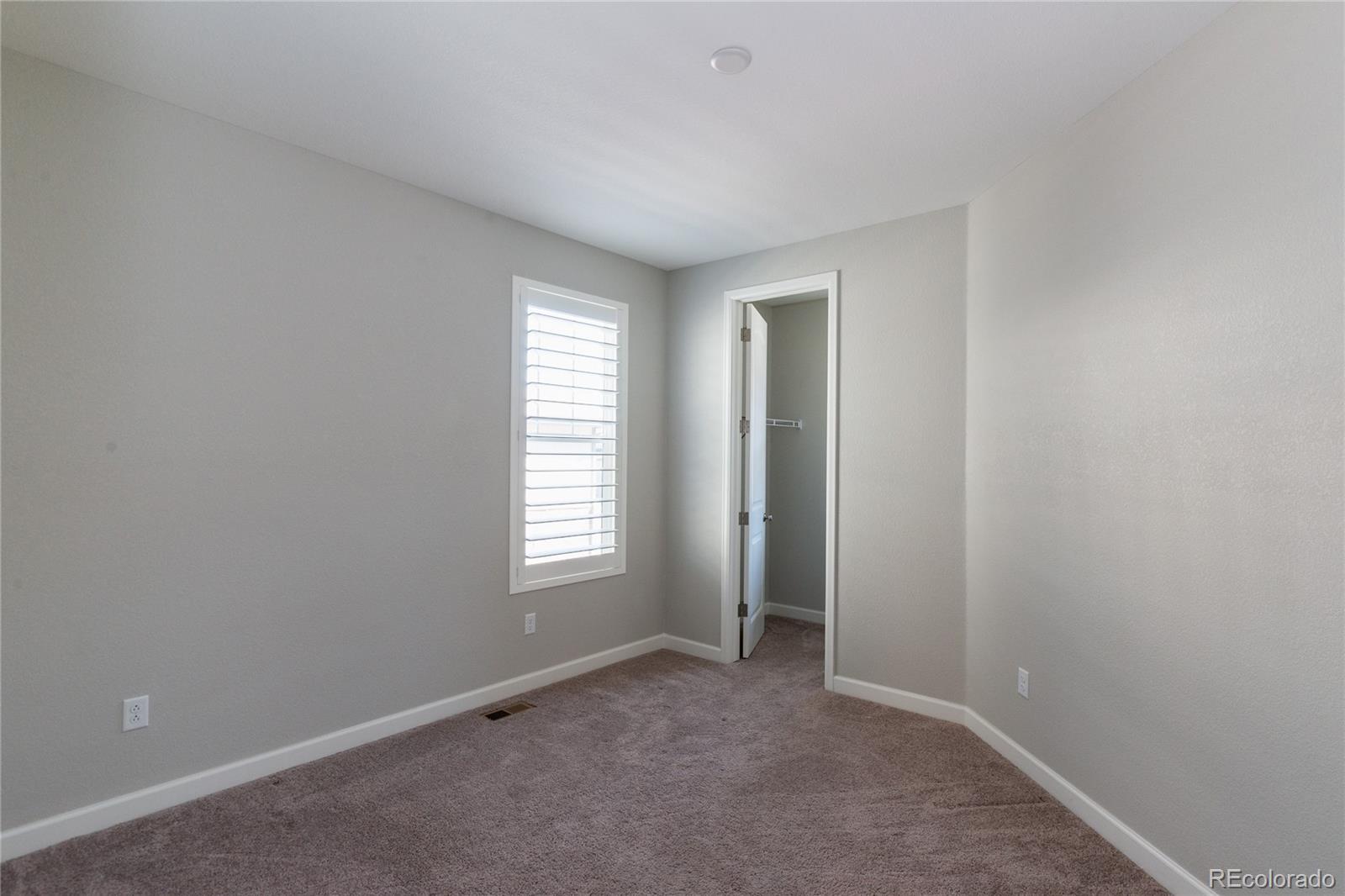515 Felicity Loop Castle Rock, CO 80109 - Photo 11 of 24 an empty room with windows and closet