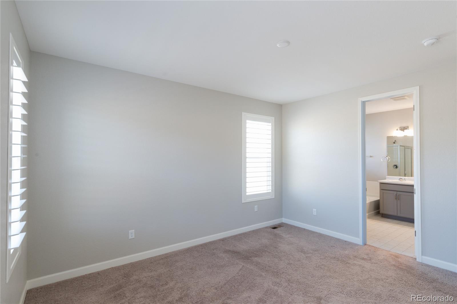 515 Felicity Loop Castle Rock, CO 80109 - Photo 6 of 24 an empty room with windows and bathroom