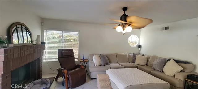 a living room with furniture chandelier and a window