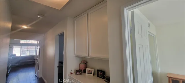 a view of a patio with furniture and table under an umbrella