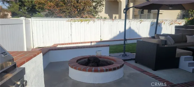 a backyard of a house with table and chairs