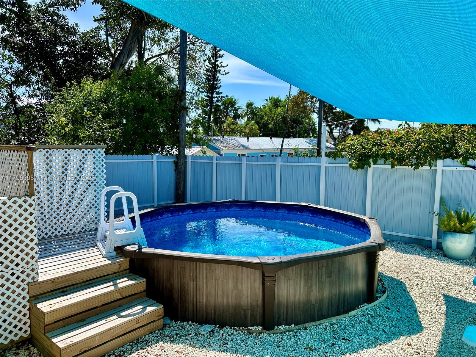 730 Largo Road Key Largo, FL 33037 - Photo 12 of 29 a view of a backyard with a tub and chairs