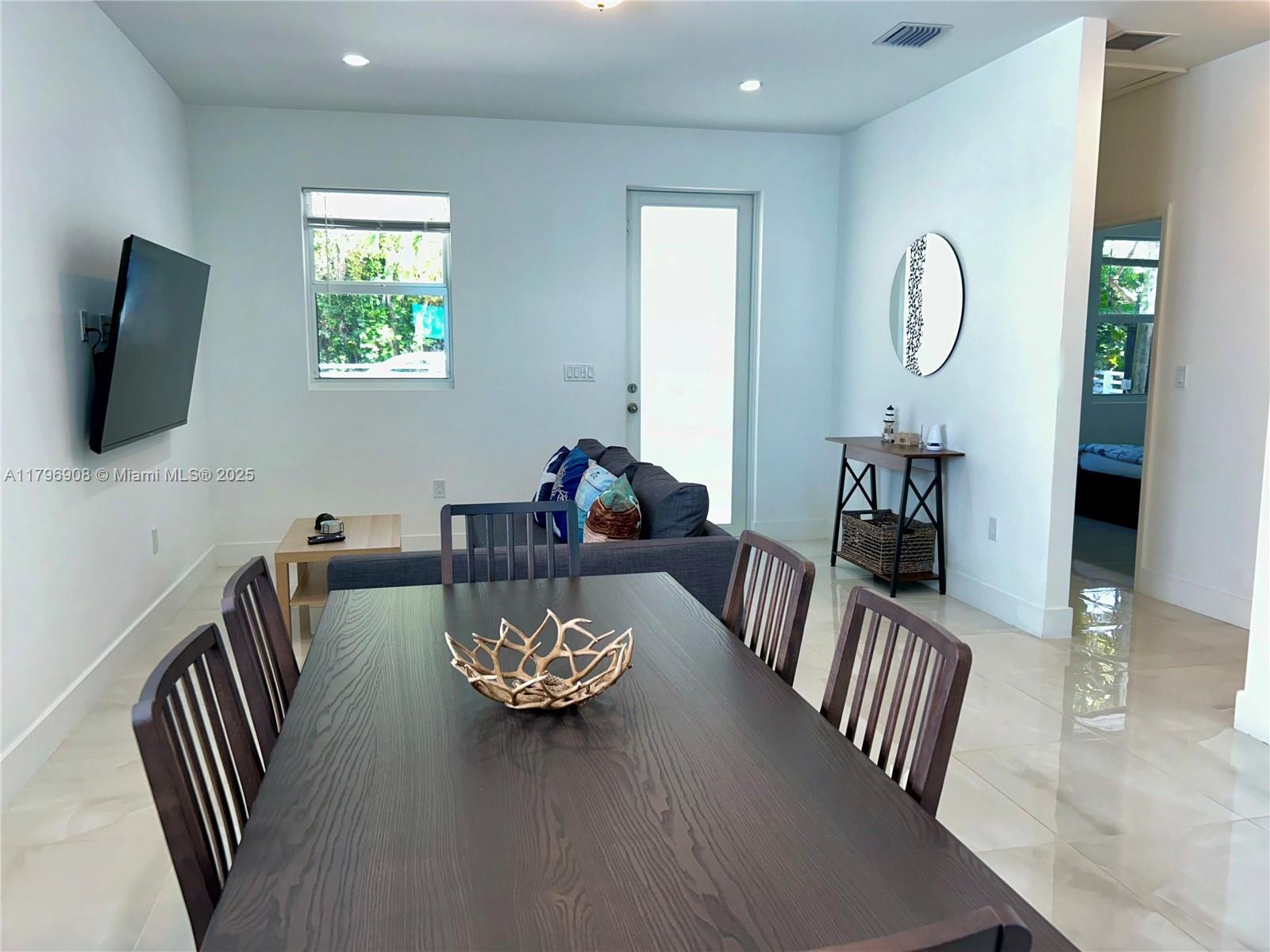 730 Largo Road Key Largo, FL 33037 - Photo 15 of 29 a view of a dining room with furniture