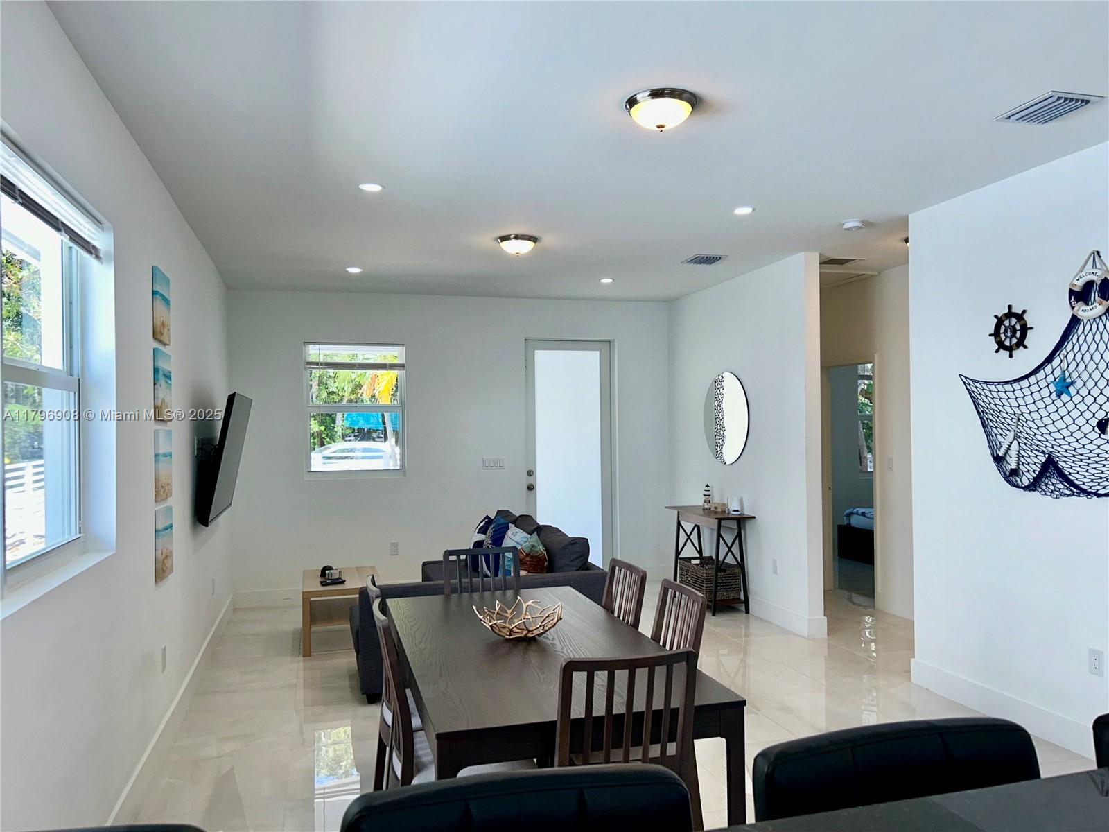 730 Largo Road Key Largo, FL 33037 - Photo 16 of 29 a view of a dining room with furniture