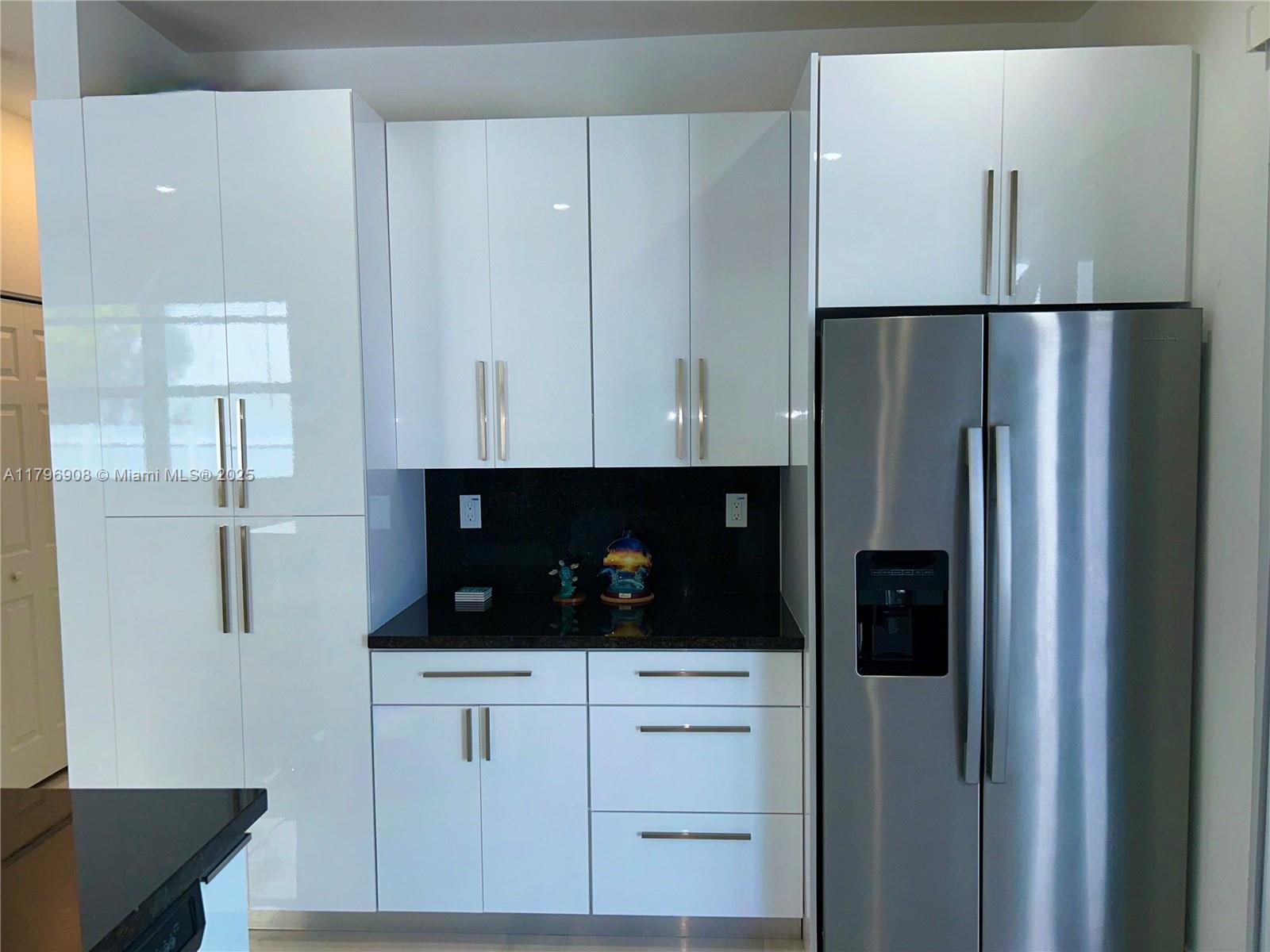 730 Largo Road Key Largo, FL 33037 - Photo 18 of 29 a view of cabinets with stainless steel appliances wooden floor