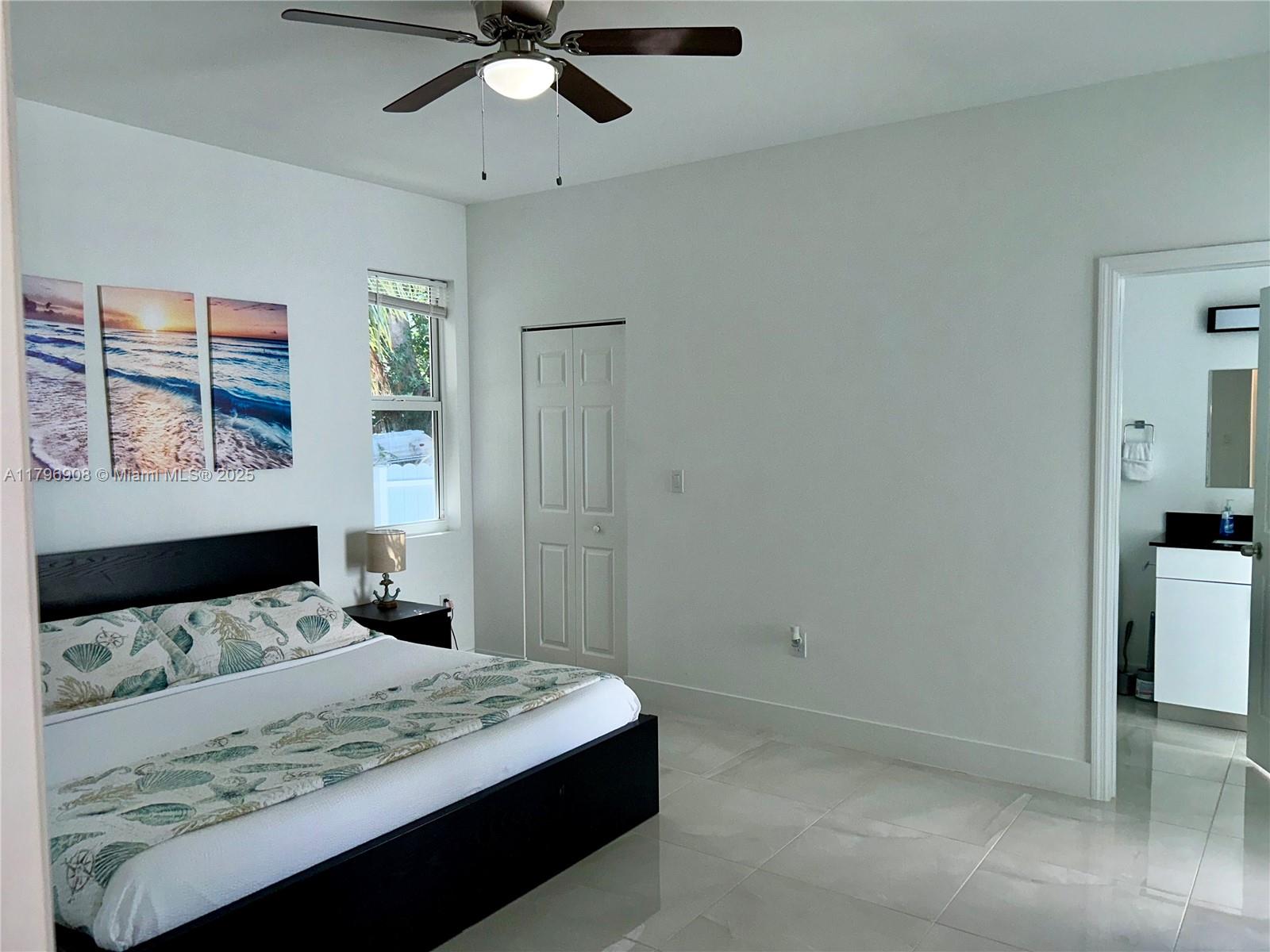 730 Largo Road Key Largo, FL 33037 - Photo 20 of 29 a bedroom with a bed and a painting on the wall