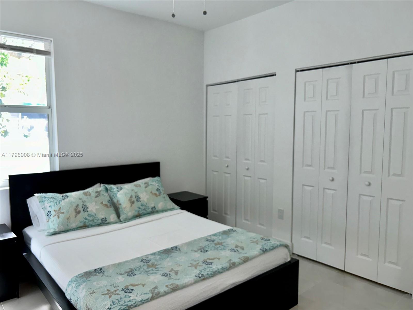 730 Largo Road Key Largo, FL 33037 - Photo 22 of 29 a bedroom with a bed and a window