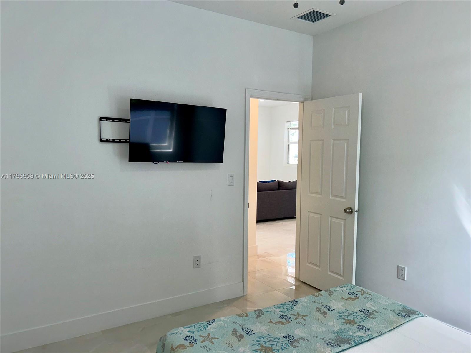 730 Largo Road Key Largo, FL 33037 - Photo 23 of 29 a bedroom with a bed and television