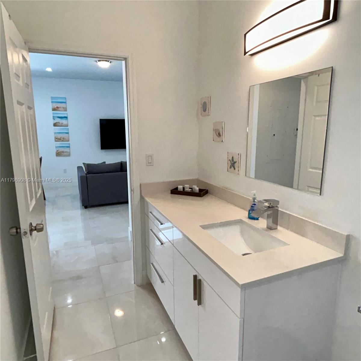 730 Largo Road Key Largo, FL 33037 - Photo 25 of 29 a en suite bathroom with a sink and a mirror