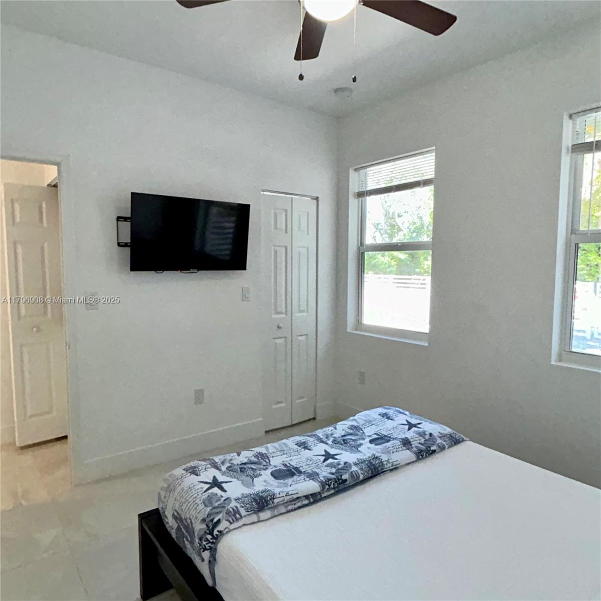 730 Largo Road Key Largo, FL 33037 - Photo 29 of 29 a bedroom with a bed and a flat screen tv