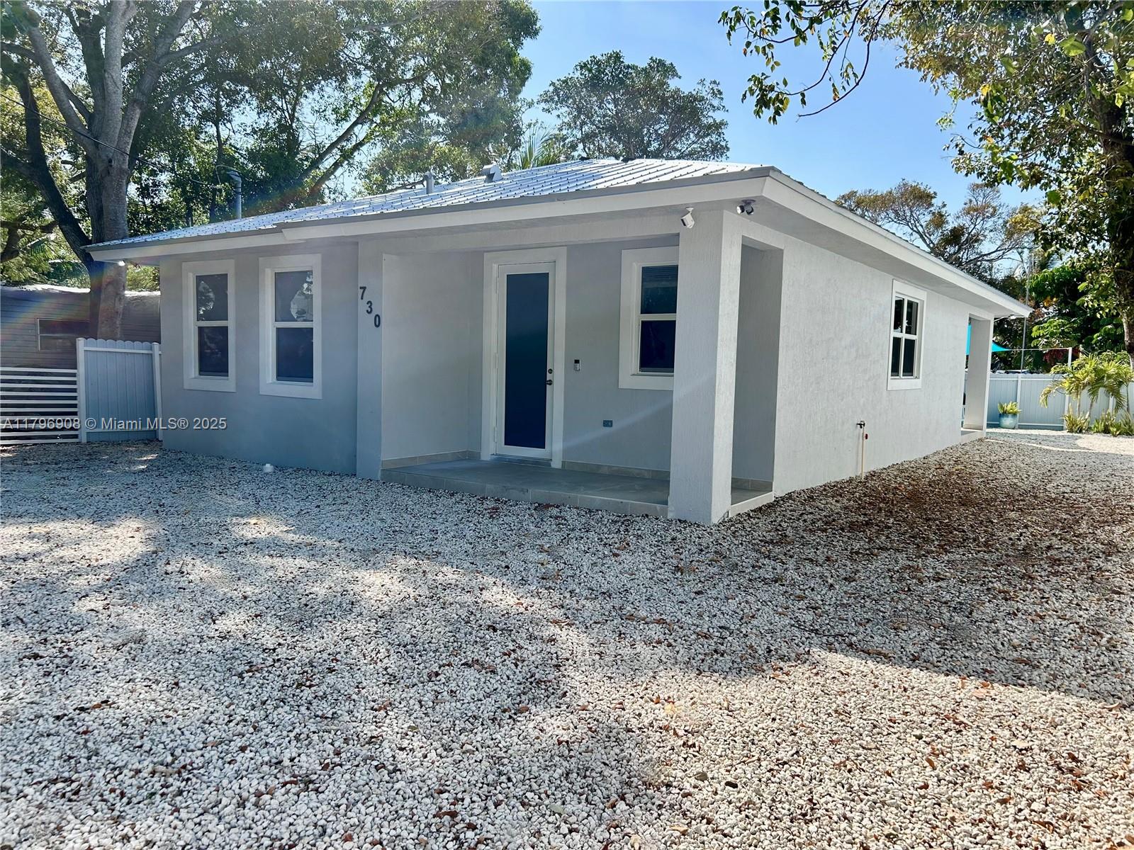 730 Largo Road Key Largo, FL 33037 - Photo 4 of 29 a view of a house with a backyard