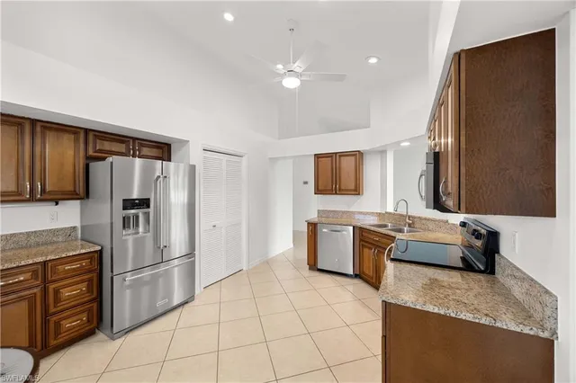a large kitchen with a large counter top appliances and cabinets