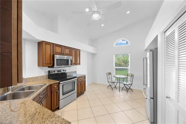 a living room with furniture a flat screen tv and large window