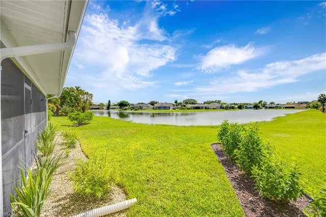 a view of a lake with houses in the back