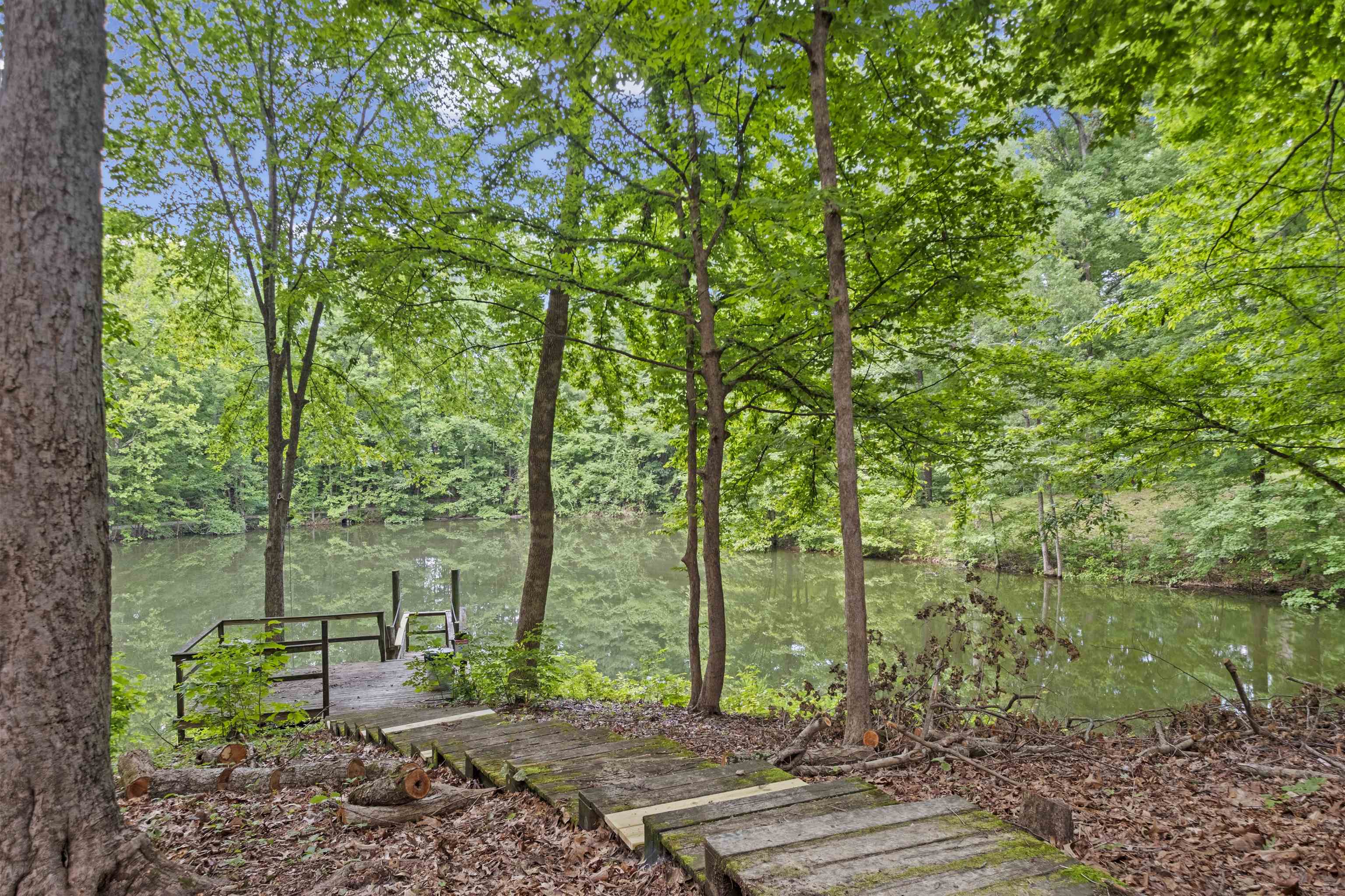 3601 Marshall Road Munford, TN 38058 - Photo 6 of 35 Waterfront property featuring a private dock, mature trees, natural wooded surroundings, and a pathway to the water
